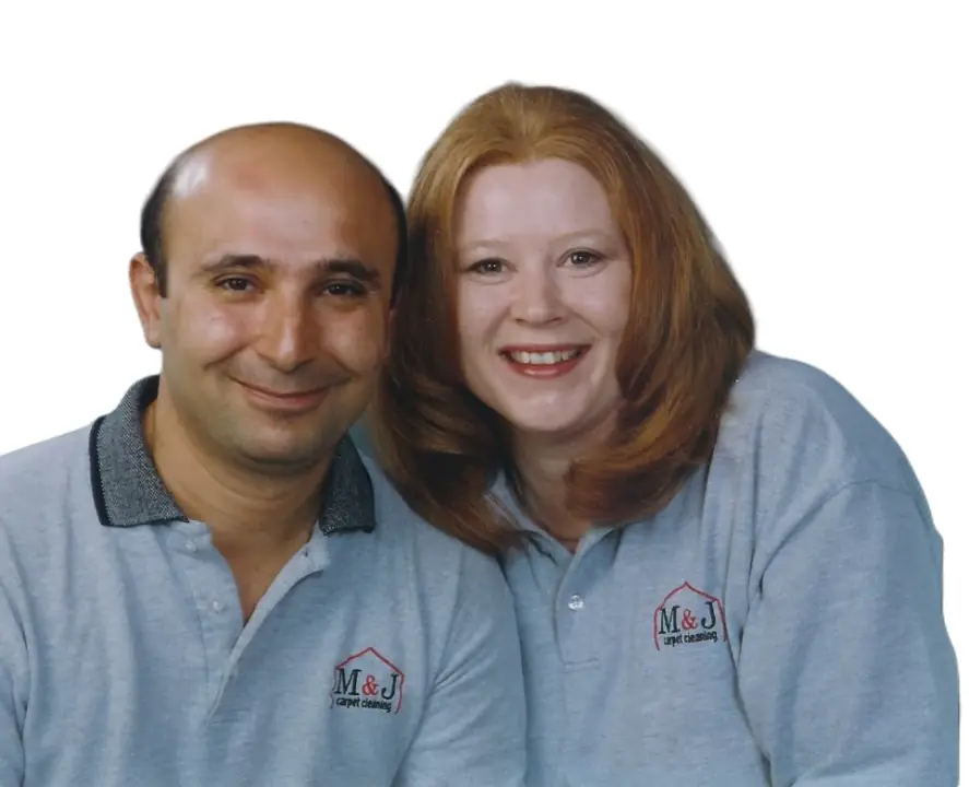 Two people in grey M&J polos with the red roof emblem